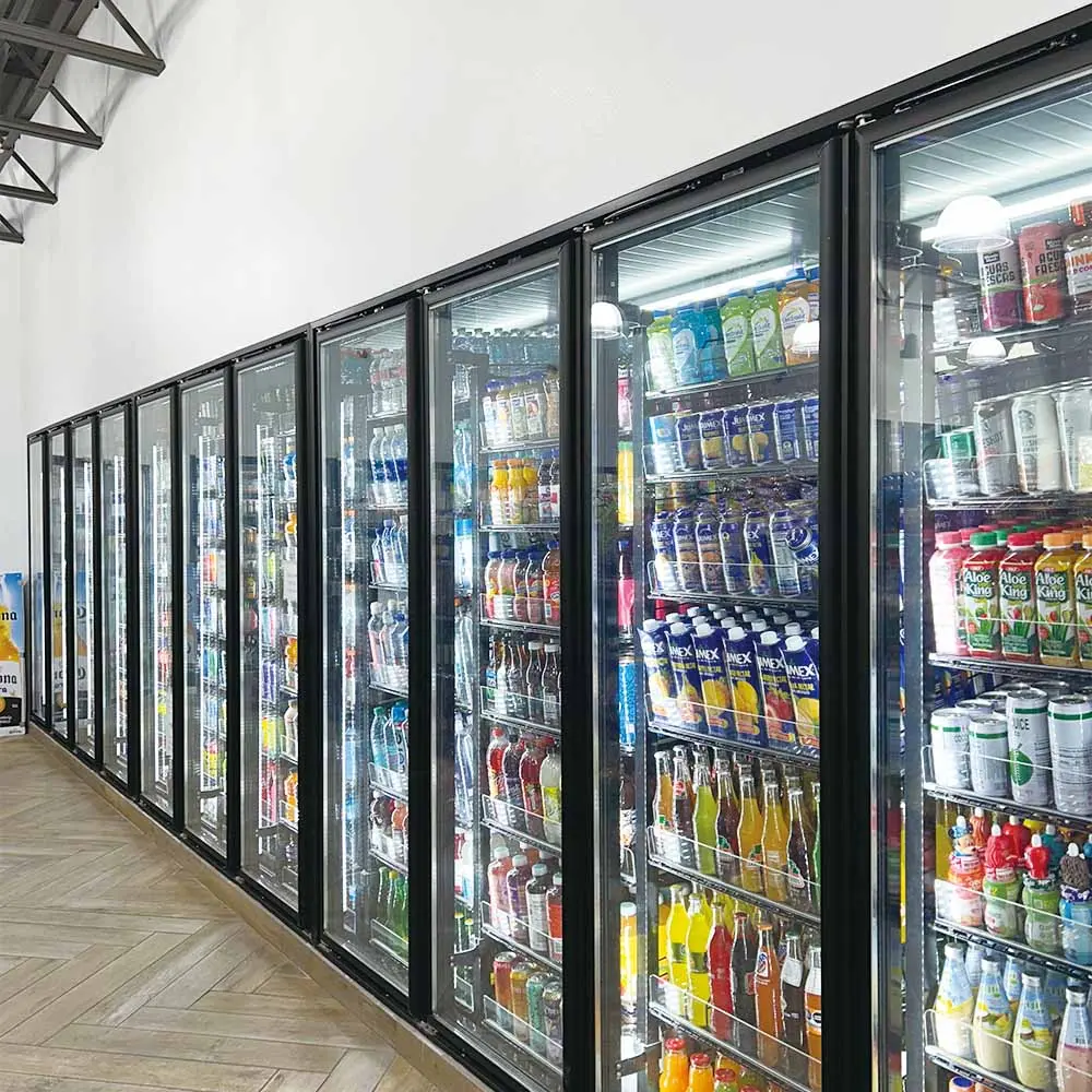 Commercial reach-in cooler glass doors installed in a retail display line