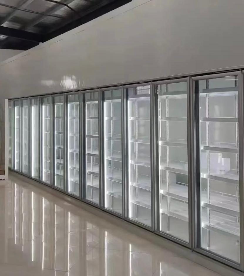 Walk-in cooler glass display doors in a supermarket aisle